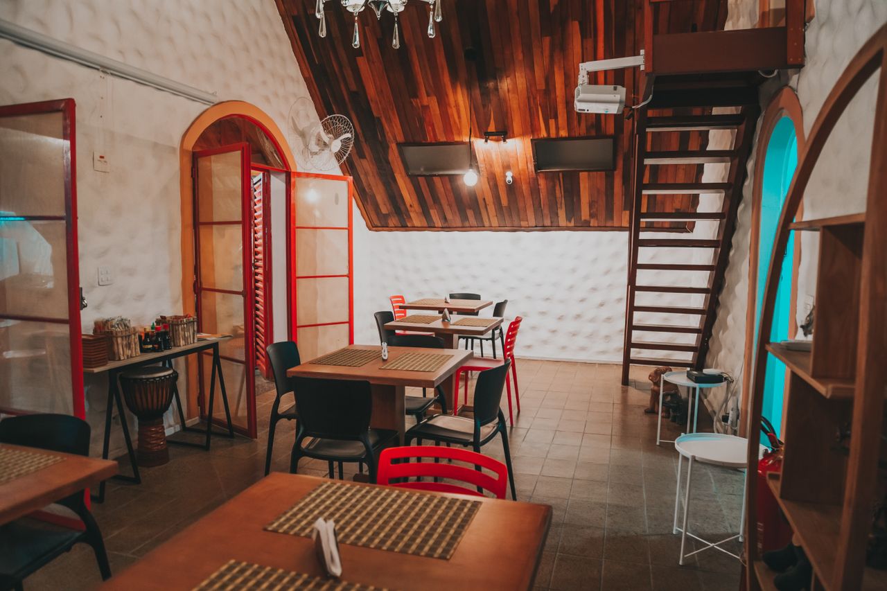 our-mission Inviting restaurant space featuring wooden ceiling and eclectic seating arrangements.