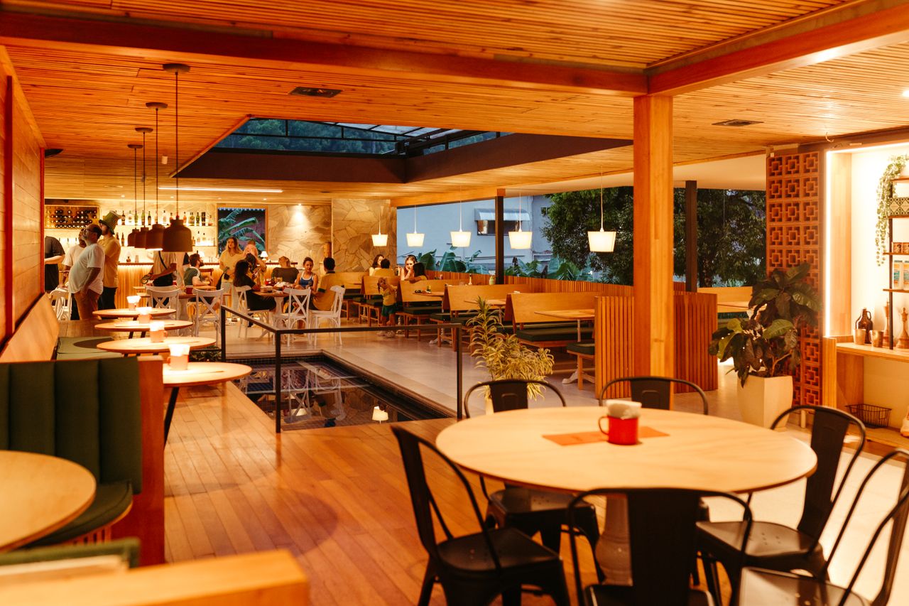stats-img Warm and inviting restaurant interior with wooden decor and ambient lighting.