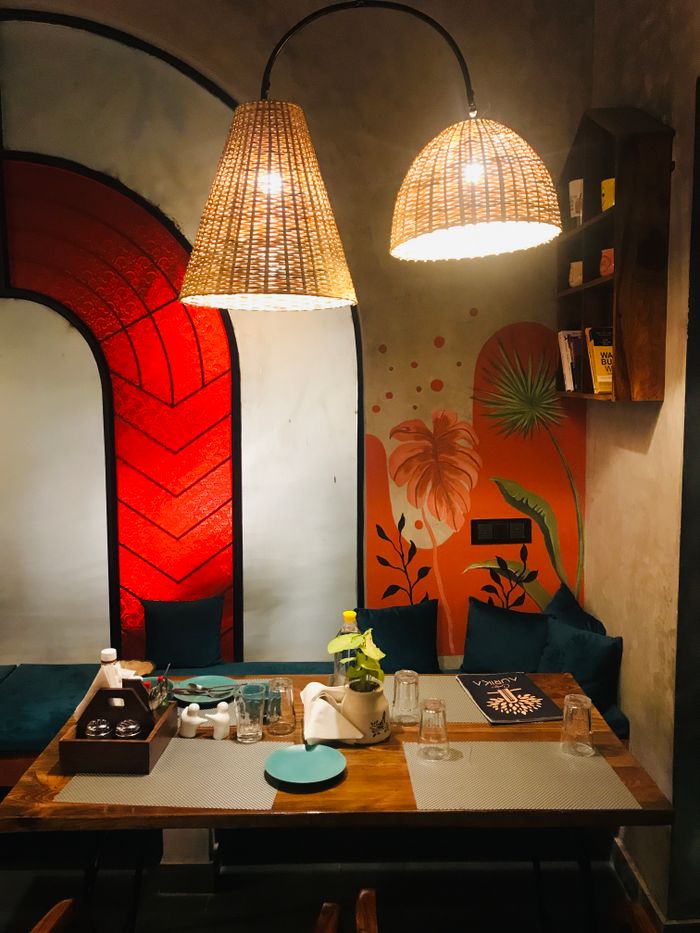 portfolio-06 Warm and inviting restaurant setting with unique lighting and colorful mural.